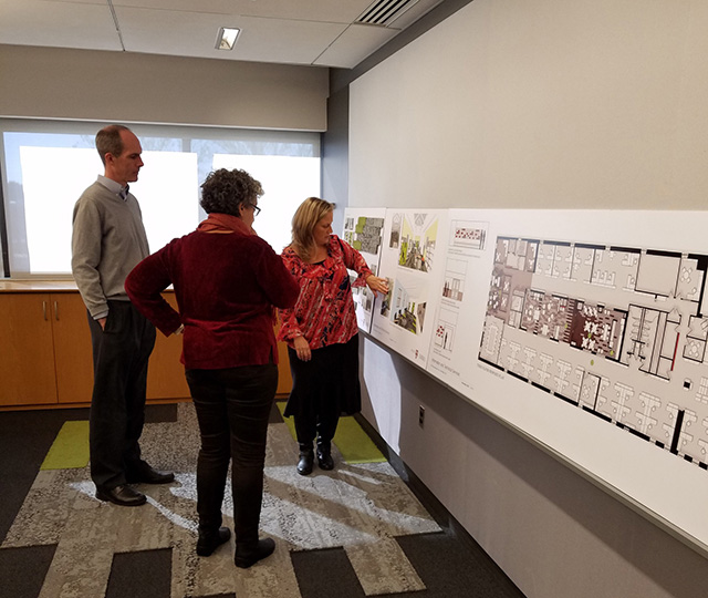 SMMA designers reviewing floor plans for new building