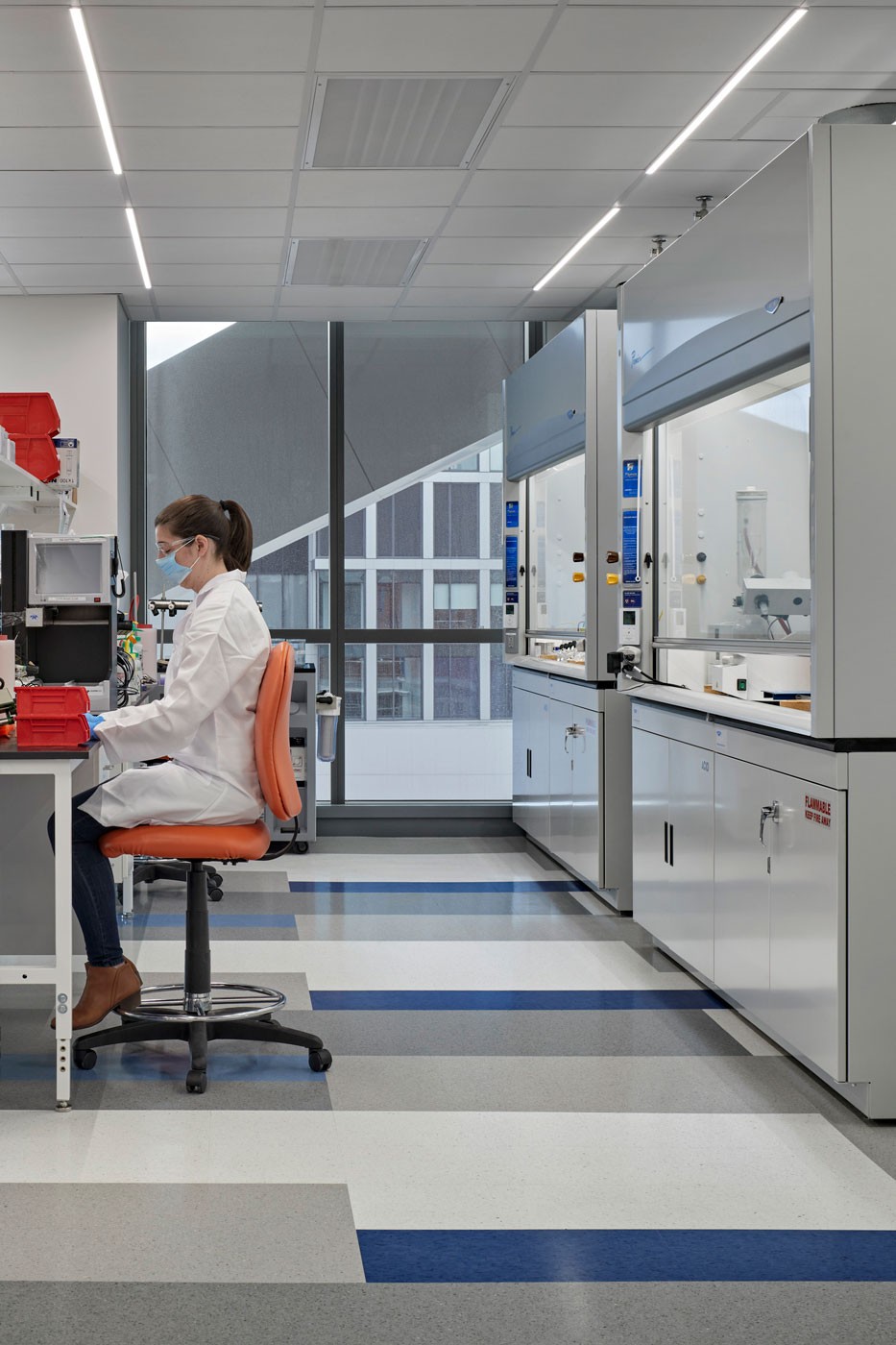 Lab worker seated at lab desk in 40 Guest Street SmartLabs property