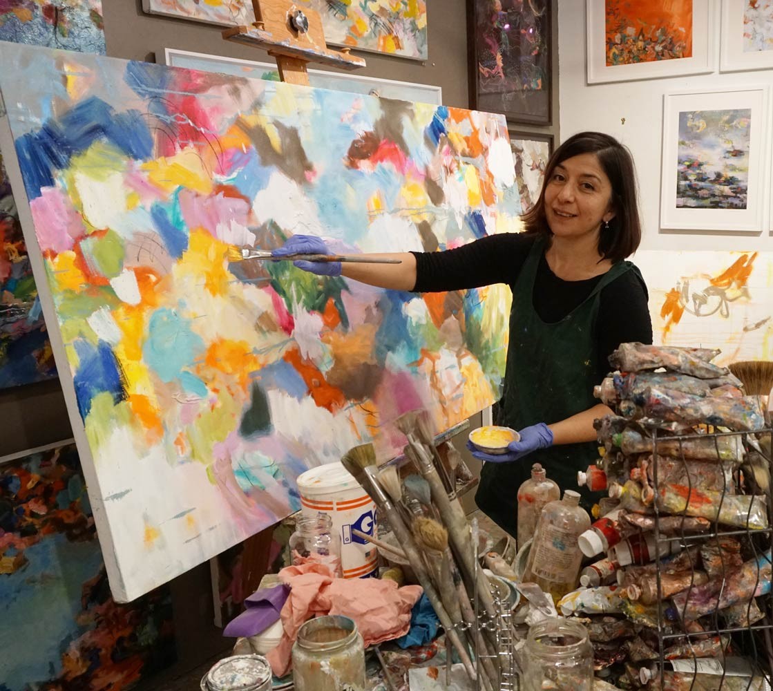 Boston based artist Nedret Andre painting in her studio